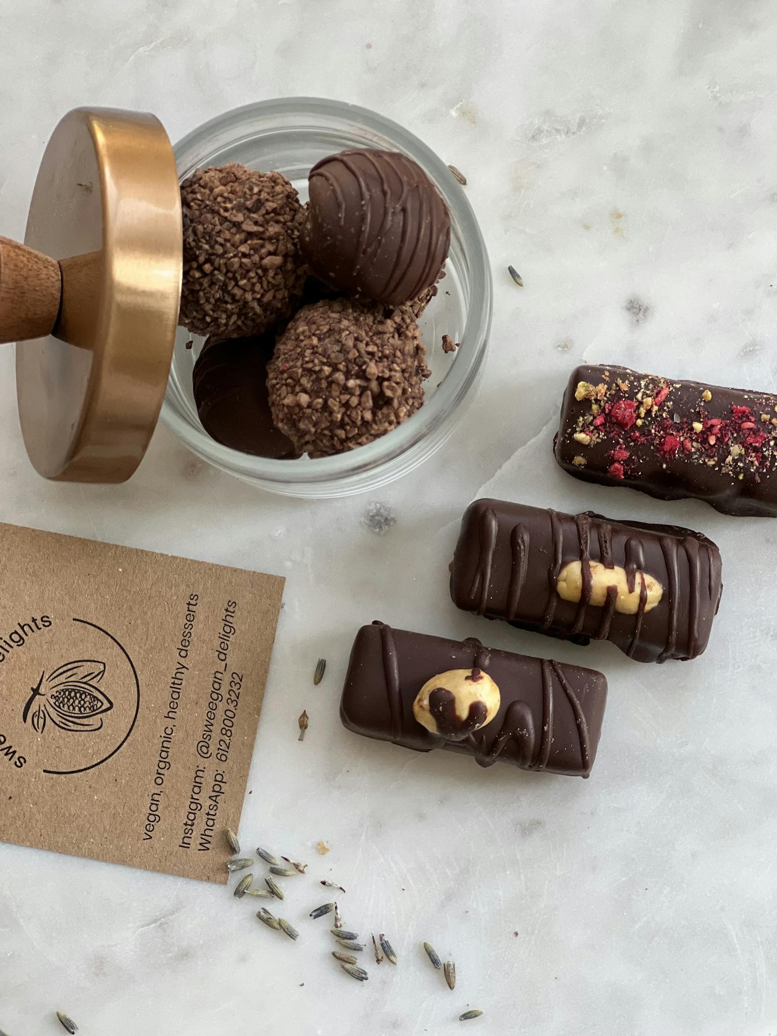 Elegant display of assorted chocolate truffles and bars with natural decor.